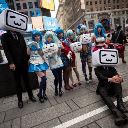 Attendees dressed in anime costumes hold Bilibili logos during the company's initial public offering (IPO) in New York. The Chinese video platform has flagged a warning on the channel of a popular vlogger suspected of spreading disinformation. Photo: Bloomberg