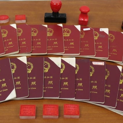 Chinese passports and stamps seized by Canadian border agents as part of an investigation into an immigration fraud scheme in Vancouver in 2015. Photo: Canada Border Services Agency