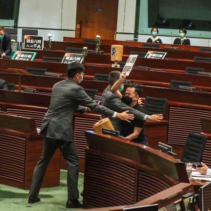 Legislative Council security guards tackle Raymond Chan after he left his seat during the debate on the national anthem law. Photo: Nora Tam