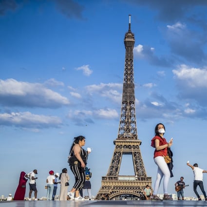 People dance to music at the Trocadero Human Rights Plaza near the Eiffel Tower in Paris on June 2. France has started a gradual lifting of Covid-19 lockdown restrictions in an effort to restart its economy and help people get back to their daily routines. Photo: EPA