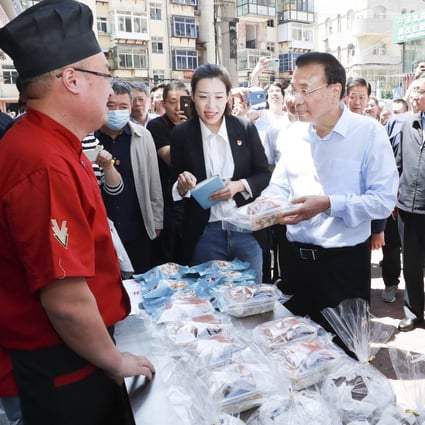 In a visit to the city of Yantai in Shandong province this week, Premier Li Keqiang said street stalls and small shops “are important sources of jobs” and an integral part of people’s normal lives. Photo: Xinhua