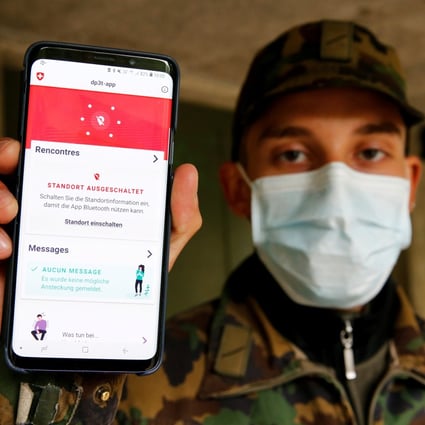 A Swiss soldier shows on a mobile device the contact tracking application created by the Swiss Federal Institute of Technology Lausanne. Photo: Reuters