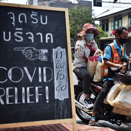 Volunteers transport packages of food and supplies from Covid Relief Bangkok to distribute to the poor. Photo: AFP