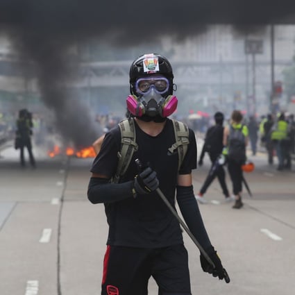 An anti-government protester holds a baton during a rally in Hong Kong last September. Photo: EPA-EFE