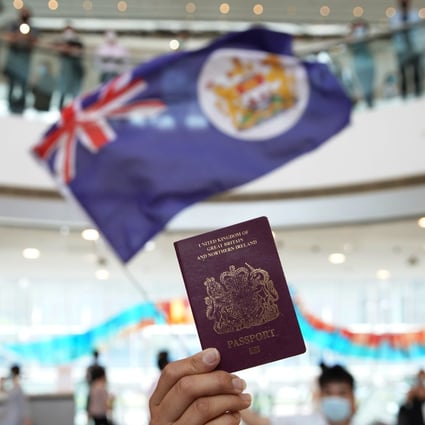 A protester holds a BN(O) passport during a lunch hour demonstration at the IFC shopping mall in Central. Photo: SCMP