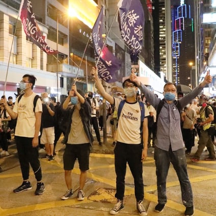 Hong Kong protesters raise their flags and mobile phone flashlights to mark the first anniversary of major anti-extradition bill protests, in Central on June 9. Photo: Dickson Lee