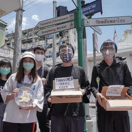 Netiwit Chotiphatphaisal and fellow Thai student activists distribute milk tea cookies in Bangkok's Chinatown to commemorate the anniversary of the 1989 Tiananmen Square crackdown. Photo: Twitter