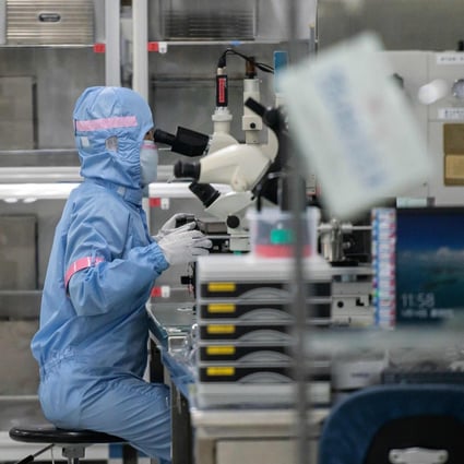 A worker is seen inside the production line at Japanese chip company Renesas Electronics in Beijing on May 14. Asia’s electronics sector has continued to grow, despite the disruptions caused by the coronavirus pandemic. Photo: Agence France-Presse