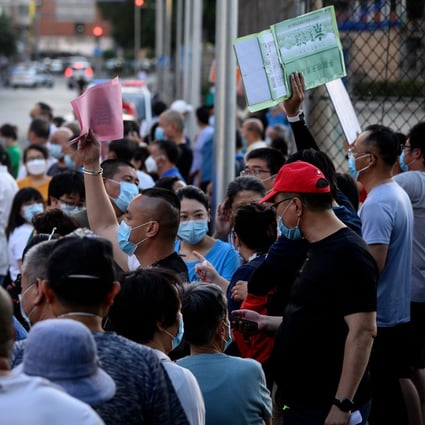 Nearby residents and people who visited Beijing’s Xinfadi market queue to be tested for Covid-19. Photo: AFP