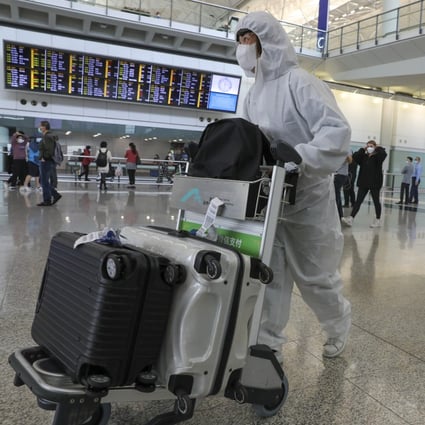 University student Amy Chan walks through Hong Kong International Airport on March 16 after returning from her studies in the United Kingdom amid the Covid-19 pandemic. Photo: K.Y. Cheng