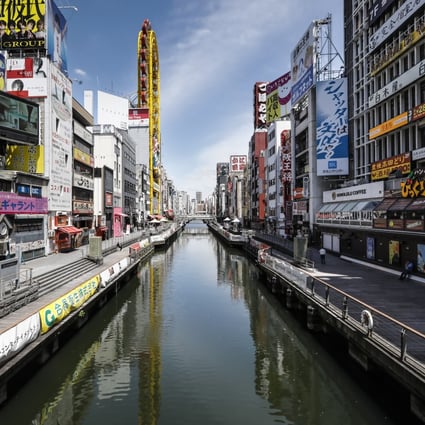 The Dotonbori neighbourhood in Osaka is usually packed with tourists and shoppers. The number of infections in the region has gradually declined and businesses have been slowly reopening but the streets remain quiet. Photo: EPA