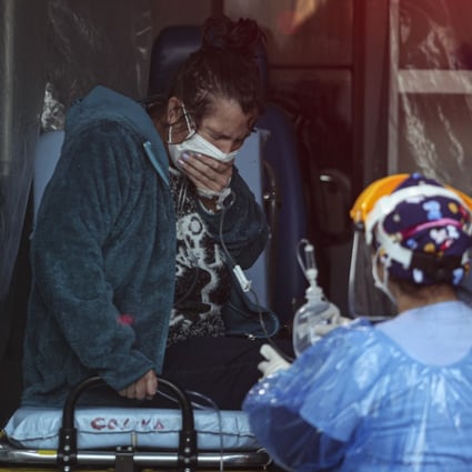 A patient with respiratory distress receives aid from a medical worker in Santiago, Chile. Photo: AP