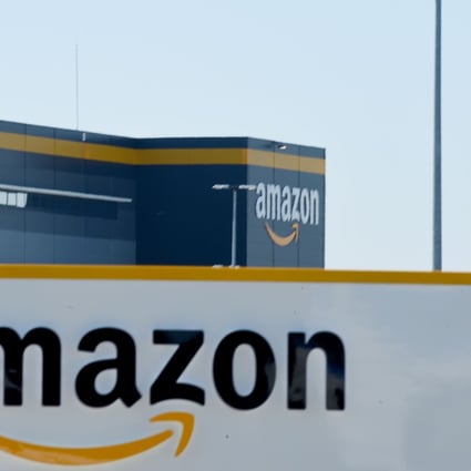 This illustration picture taken in Bretigny-sur-Orge on May 19, 2020 shows a sign with the company's logo at Amazon's centre entrance. Photo: AFP