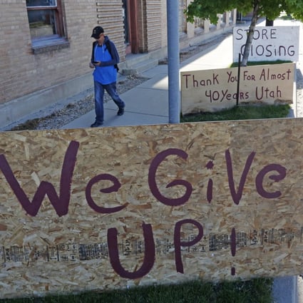 Signs outside an art and antique shop closing down in Salt Lake City on May 8. Millions without jobs also lose health insurance as Covid-19 widens inequalities in the US. Photo: AP