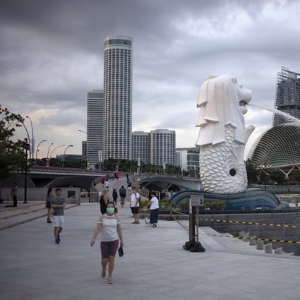 People walk through the Merlion Park in Singapore on June 11. The country has laws that empower the state to act against anyone who causes feelings of enmity between different religious groups. Photo: EPA-EFE