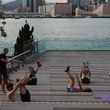 A group of people exercising together at Tamar Park, Admiralty, Hong Kong during the coronavirus pandemic. It has shaken up people’s routines, brought family members closer together, and fostered the practise of mindfulness, experts observe. Photo: K.Y. Cheng