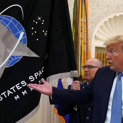 US President Donald Trump views the new Space Force flag in May. The military branch was officially established in December. Photo: Reuters