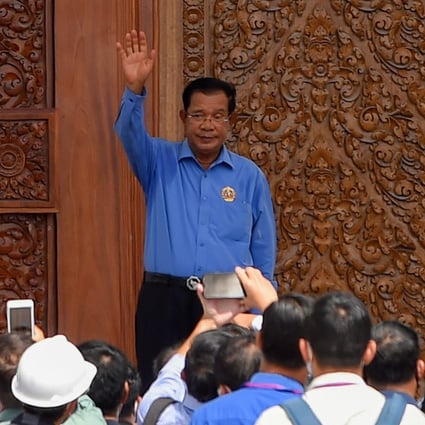 Cambodia's Prime Minister Hun Sen waves during his visit to the Cambodian People's Party headquarters, currently under construction in Phnom Penh. Photo: AFP