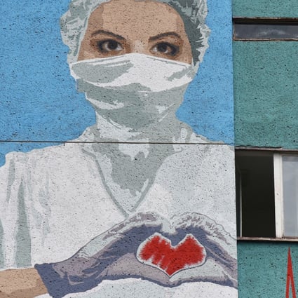 A mural depicting a health care worker is seen on a wall of the City Emergency Hospital in Lviv, Ukraine on Sunday. Photo: Reuters