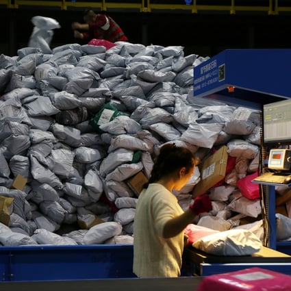 Employees sort out parcels at a logistics base in Yiwu, a city in eastern Zhejiang province, during China’s Singles’ Day shopping festival on November 11, 2019. Photo: Reuters