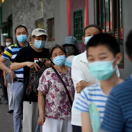 People line up to be tested for the coronavirus in Beijing on Sunday. Photo: AFP