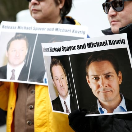 People hold signs calling for China to release Canadian detainees Michael Spavor and Michael Kovrig at a demonstration held in March. Photo: Reuters