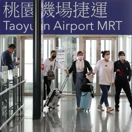 Travellers arrive at Taipei’s Taoyuan airport in March, before foreign travellers and international flight transfers were suspended. Photo: Reuters