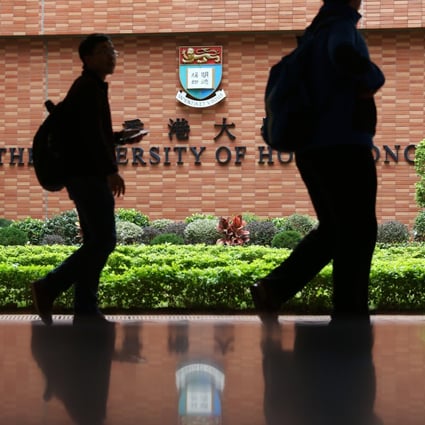 Visitors walk past a logo of the University of Hong Kong in Pok Fu Lam. Photo: Nora Tam