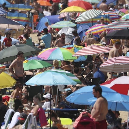 Crowds gather on the beach in Bournemouth, England on Thursday. Photo: PA via AP