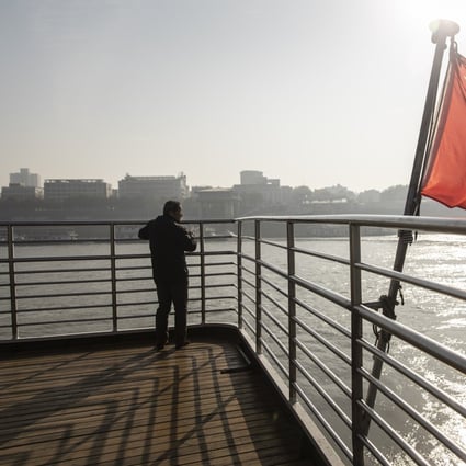 A Chinese national flag flies on the deck of a ferry crossing the Yangtze River in Wuhan, China in December 2019. Investors are speeding up their M&A deals in China this year while Chinese investors pull back from overseas market. Photo Handout