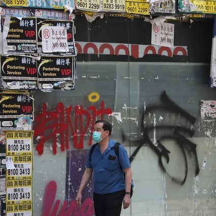 A man walks past a closed retail store in Wan Chai on April 30. Over 2,000 Hong Kong companies filed for bankruptcy in May. Photo: Xiaomei Chen
