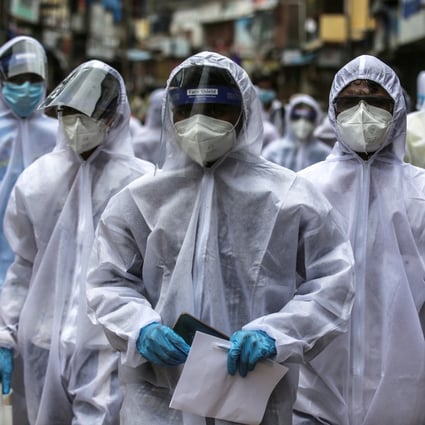 Indian health workers wearing personal protective equipment arrive at a coronavirus hotspot in Mumbai. Photo: EPA