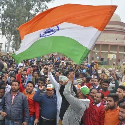 An Indian man waves the national flag at Wagah, near the border with Pakistan. India’s relations with its neighbours have deteriorated, as it is increasingly perceived as a regional bully. Photo: AP