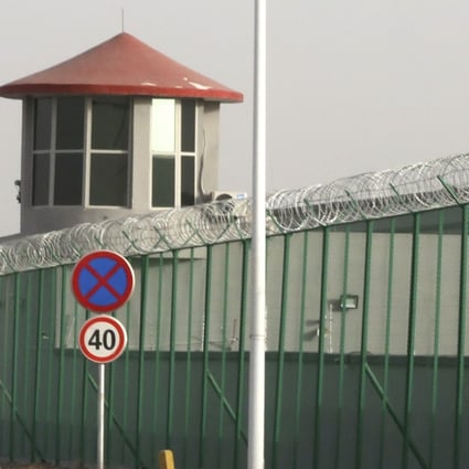 A guard tower and barbed wire fence surround a detention facility in Xinjiang in December 2018. Photo: AP