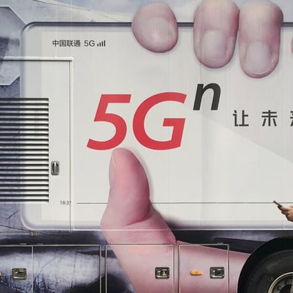 A woman using her mobile phone walks past a vehicle covered in a China Unicom 5G advertisement in Beijing, China September 17, 2019. Photo: Reuters