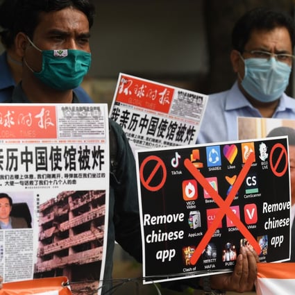 Members of the organisation Working Journalists of India hold placards urging citizens to remove Chinese apps and stop using Chinese products during a demonstration in New Delhi on June 30. Photo: Agence France-Presse