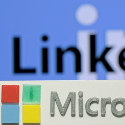 A 3D printed logo of Microsoft is seen in front of a displayed LinkedIn logo. Photo: Reuters