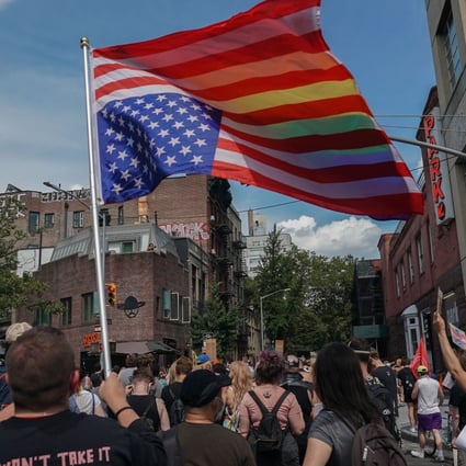 A man carries the American flag upside-down during the Queer Liberation March in New York on Sunday. Photo: AFP