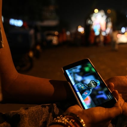 An Indian youngster watches a cricket match on his smartphone. China’s two largest telecoms equipment vendors, Huawei Technologies and ZTE Corp, could be shut out of the roll-out of superfast 5G mobile networks in India amid rising tensions between the two countries. Photo: EPA-EFE