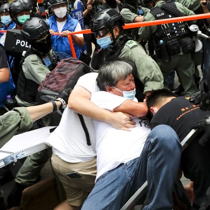 Veteran opposition politician Lee Cheuk-yan is surrounded by riot police during an illegal demonstration against Hong Kong’s new national security law on July 1. Photo: Sam Tsang