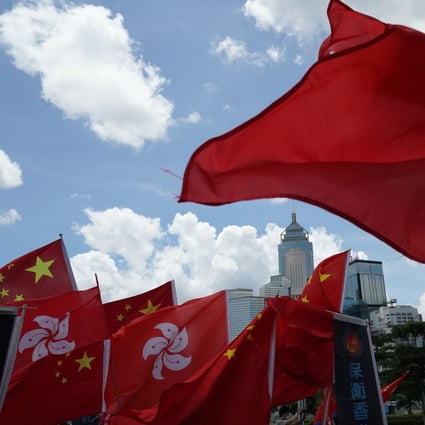 Pro-Beijing supporters wave the Hong Kong and national flag to celebrate the passage of the national security law on Tuesday. Photo: Felix Wong