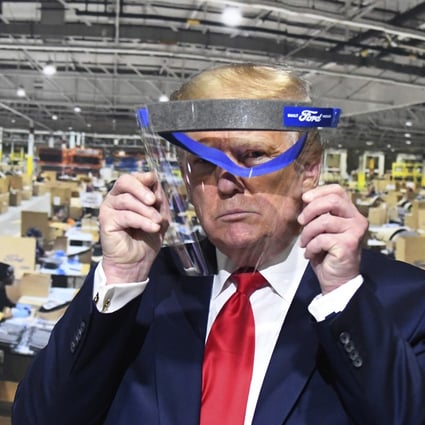 US President Donald Trump looks through a face shield while touring Ford Motor Co.'s Rawsonville Components Plant in Michigan on May 21, 2020. Photo: Detroit News via AP