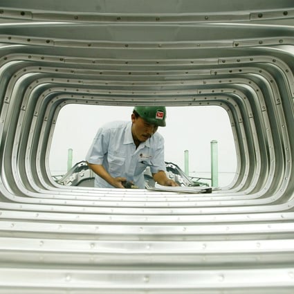An Indonesian worker assembles rear doors at a Daihatsu plant in Jakarta. Photo: Reuters