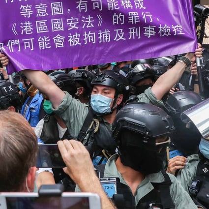 Police brought out for the first time a new, purple flag warning against breaking the national security law. Photo: Sam Tsang