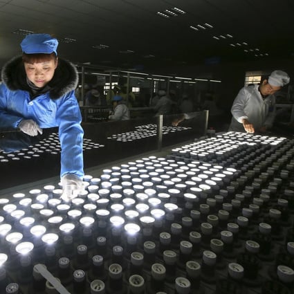 A worker tests LED lights at a factory in Suining city in southwestern China's Sichuan province on February 28, 2017. Photo: Chinatopix via AP