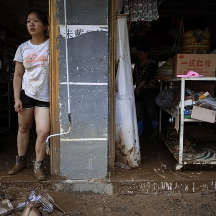 A resident looks out from her flood-damaged home in Bifeng township in Guizhou in June 13. Photo: Xinhua via AP