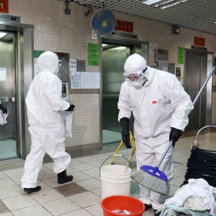 Workers disinfect a public housing block in Yuen Long where the male patient had previously lived. Photo: Dickson Lee