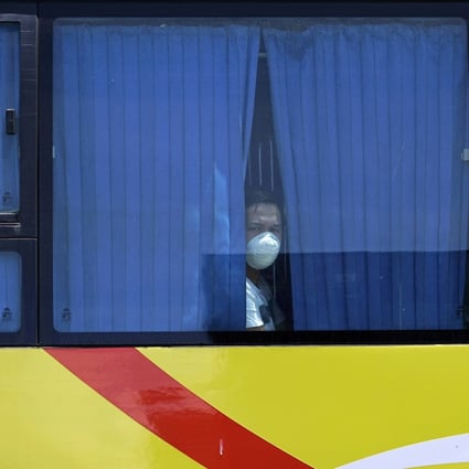 A repatriated overseas Filipino overseas worker looks on from a bus in Cebu City, the Philippines. Photo: EPA