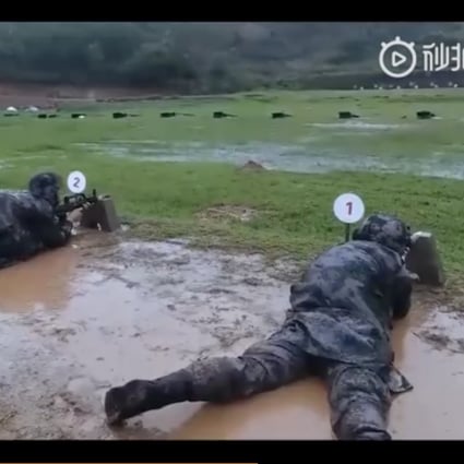 Soldiers were filmed shooting at targets while lying in the mud in an exercise described as improving their ability to “endure hardship”. Photo: Weibo