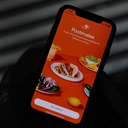 Food delivery app Postmates is seen on a smartphone screen. Photo: Agence France-Presse